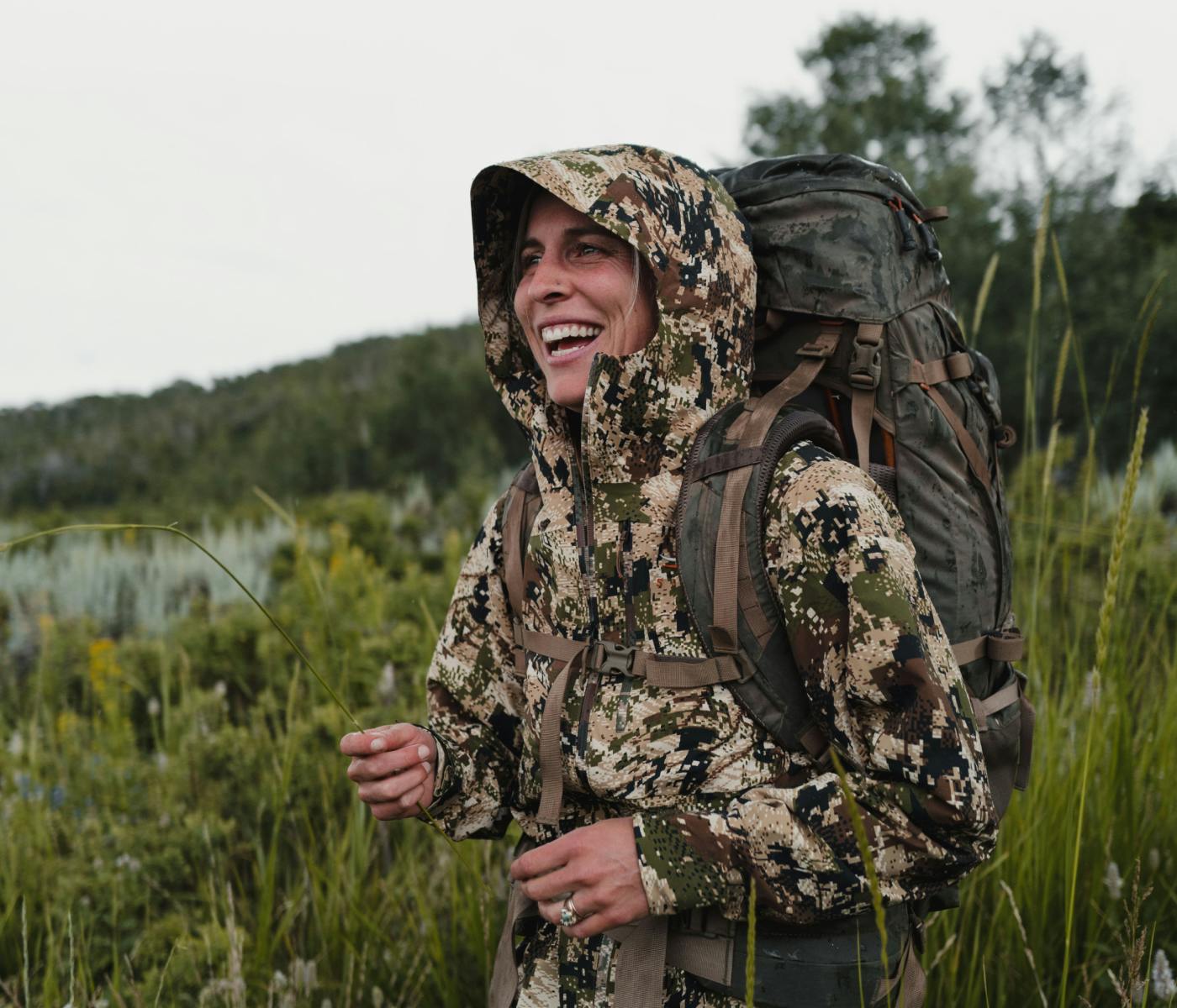 Woman in the Women's Dew Point Jacket in Optifade Sublapine | SITKA Gear